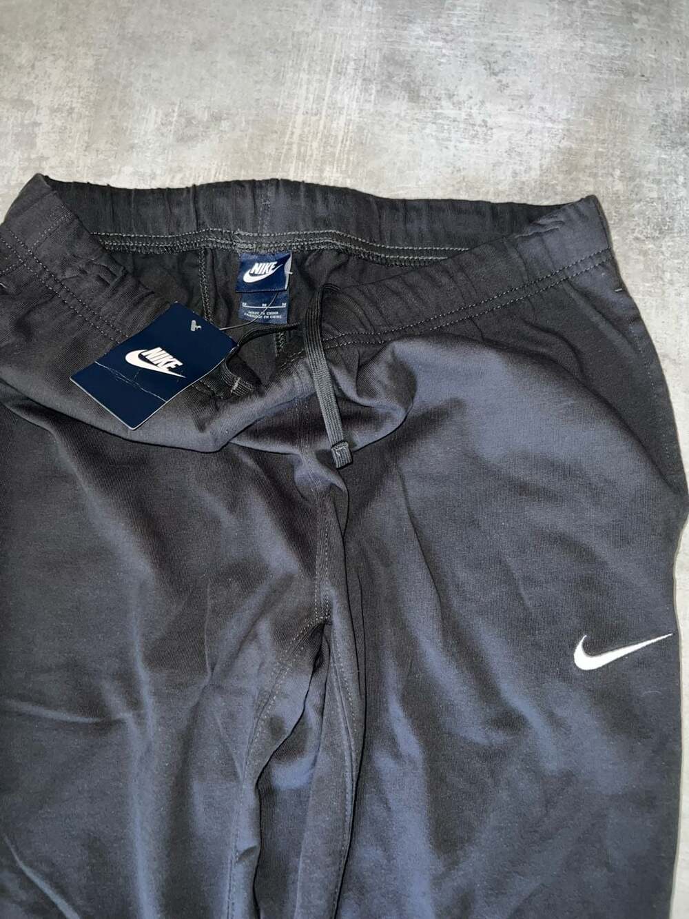 Nike Men's Black Athletic Pants with White Swoosh and Drawstring